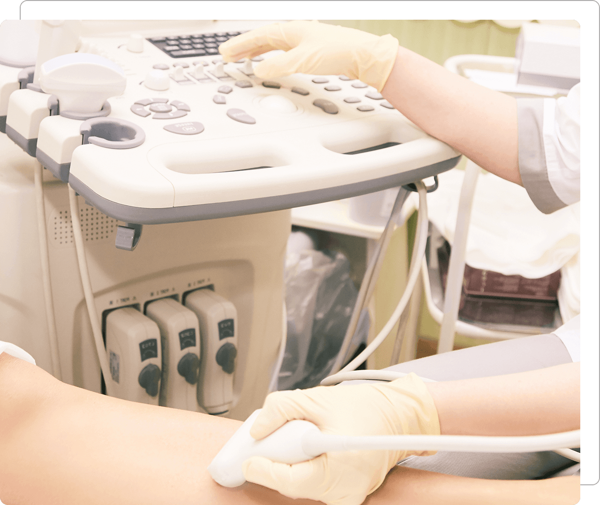 Ultrasound procedure on patient's leg in clinic.