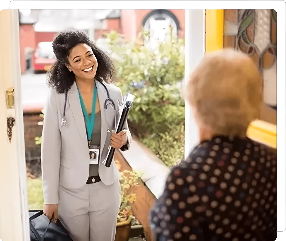Smiling healthcare professional visiting elderly woman's home